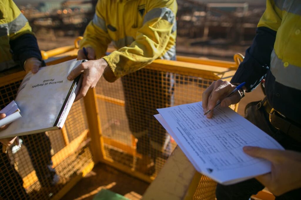 Builders looking at health and safety documentation